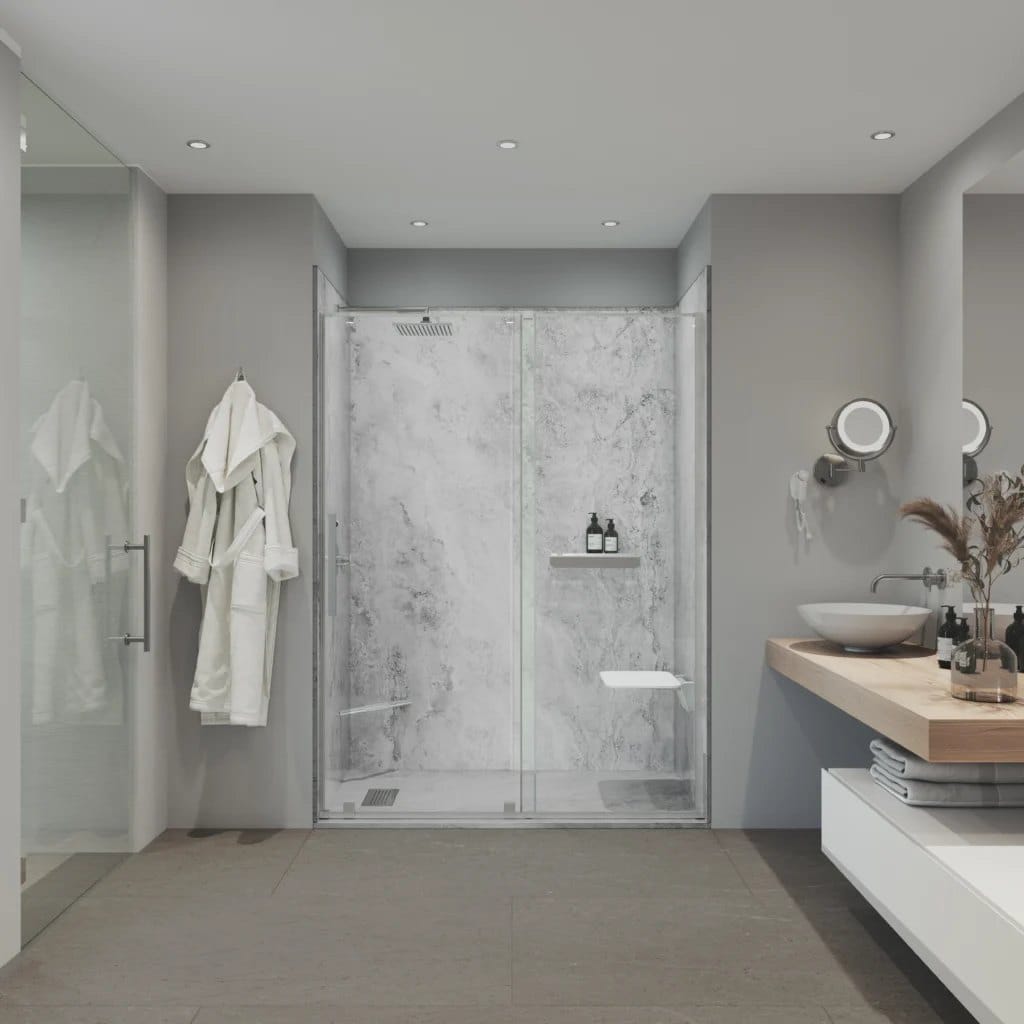 Steady & Ready walk-in shower with warm Tundra Light Gray marble-look composite wall panels, frameless glass, a polished chrome rain shower head, built-in niche, and low-threshold pan at the floor — our most popular mid-tier finish.
